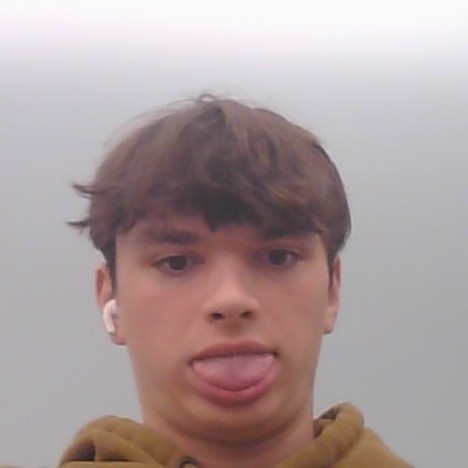 Blue smiling emoji character with wide eyes eating a cookie