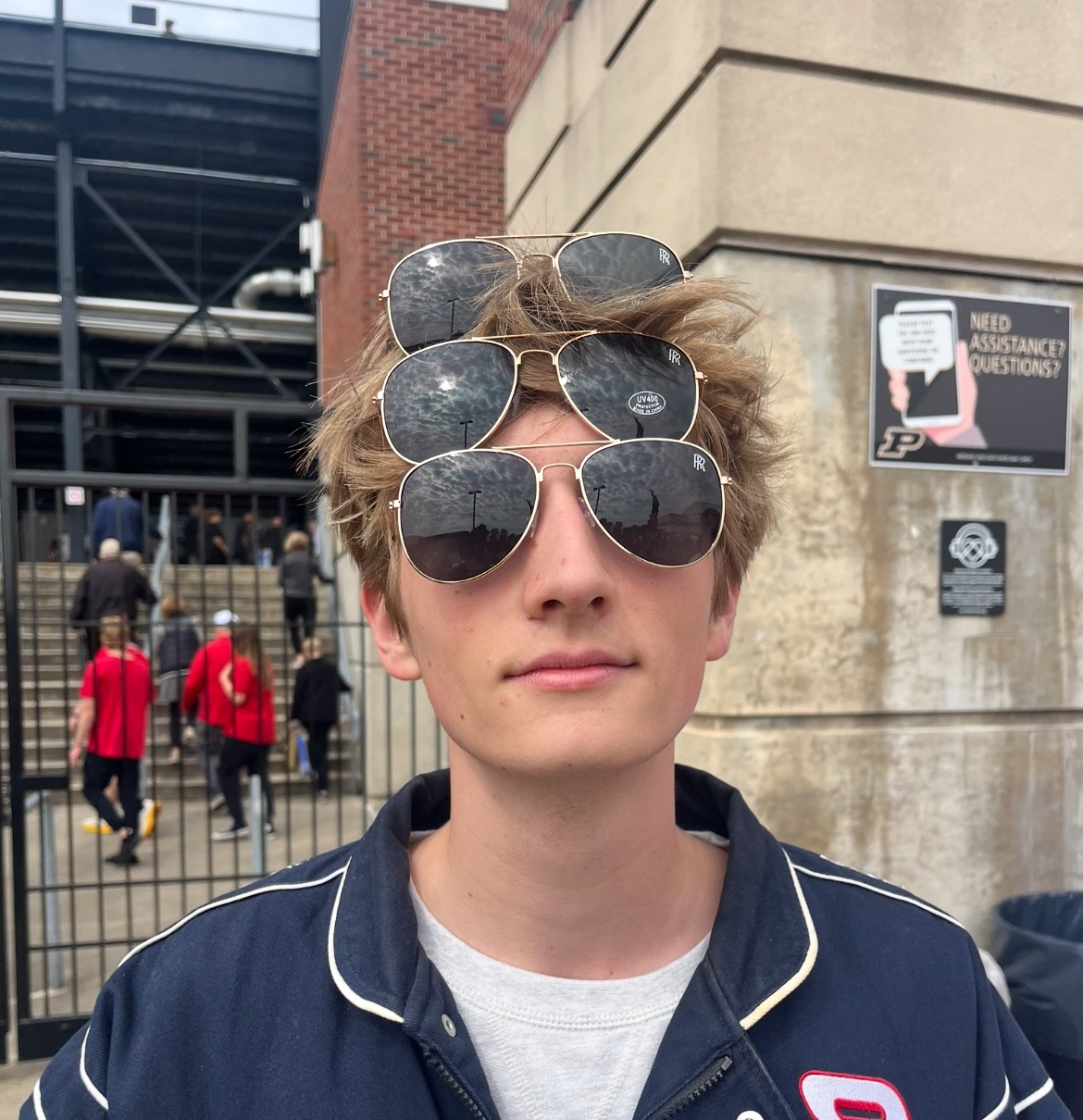 Blue smiling emoji character with wide eyes eating a cookie